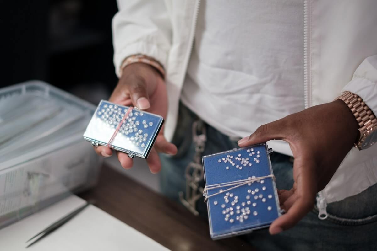 Four friends at a kitchen table playing Texas Hold'em with phones showing PartyPot chip stacks